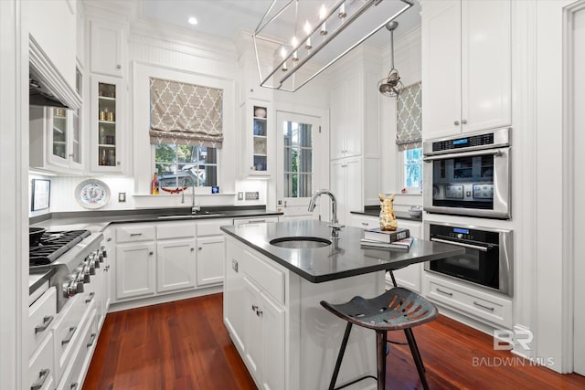 212 S Cedar St, Mobile, AL 36602 - kitchen featuring a sink, stainless steel appliances, dark countertops, white cabinetry, and crown molding