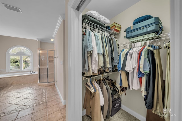 spacious closet with light tile patterned floors