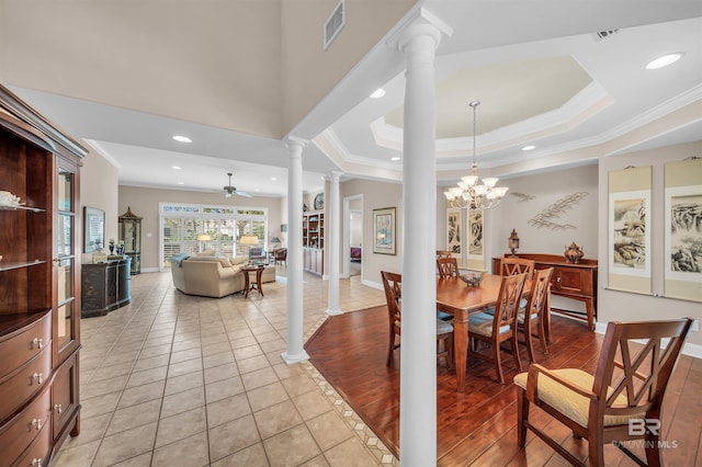 dining room featuring ceiling fan with notable chandelier, decorative columns, light hardwood / wood-style flooring, and crown molding