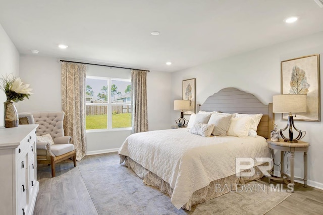 bedroom with baseboards, light wood-style flooring, and recessed lighting