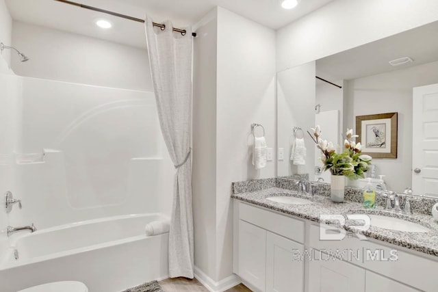 bathroom with double vanity, recessed lighting, a sink, and shower / bathtub combination with curtain