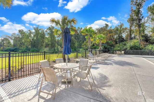 view of patio with fence and outdoor dining area