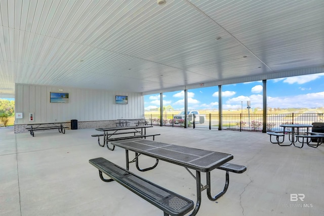 view of community featuring fence and a patio area