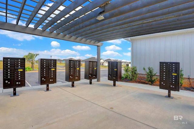 surrounding community featuring a pergola and mail area
