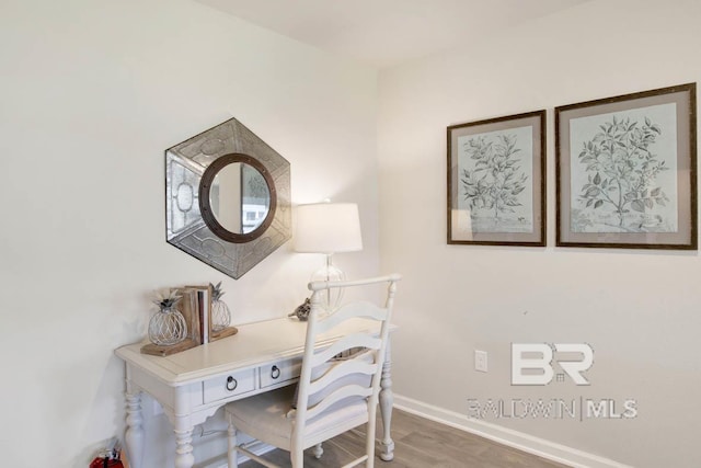 home office featuring baseboards and wood finished floors