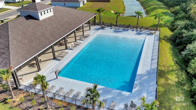 community pool with fence and a patio area