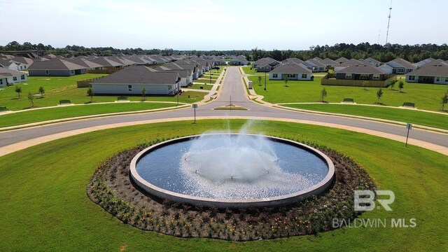 view of property's community featuring a residential view and a yard
