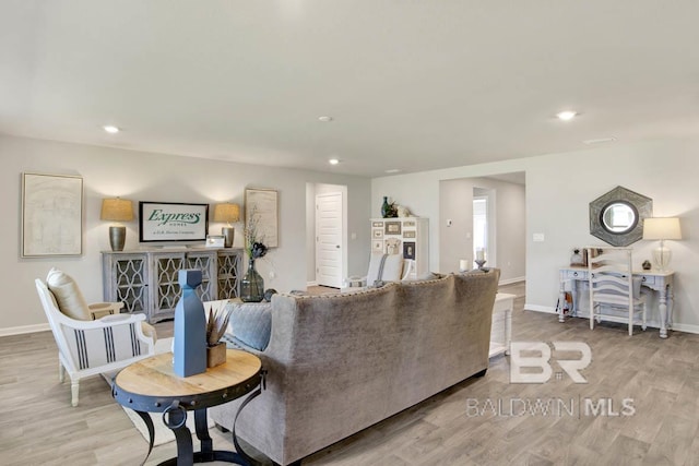 living room with baseboards, wood finished floors, and recessed lighting