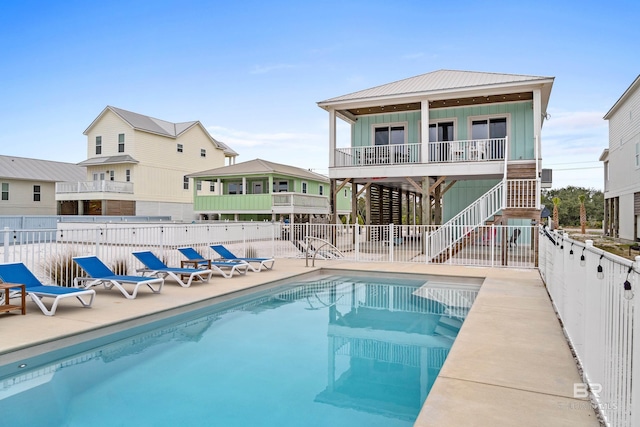 back of house featuring a patio area and a community pool