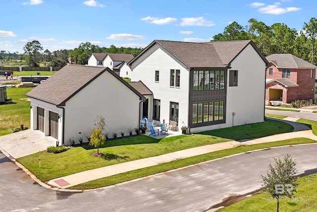 view of front of home with french doors, a patio area, and a front yard