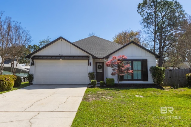 5100 Pine Way, Orange Beach, AL 36561 - ranch-style house featuring driveway, board and batten siding, an attached garage, a front yard, and roof with shingles