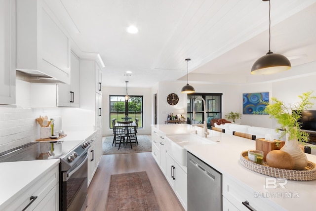5100 Pine Way, Orange Beach, AL 36561 - kitchen featuring light countertops, a sink, light wood-style floors, appliances with stainless steel finishes, and white cabinetry