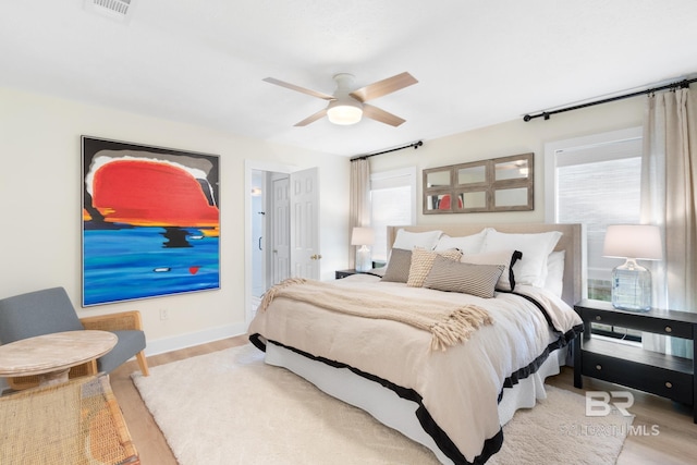 5100 Pine Way, Orange Beach, AL 36561 - bedroom featuring a ceiling fan, baseboards, multiple windows, and wood finished floors