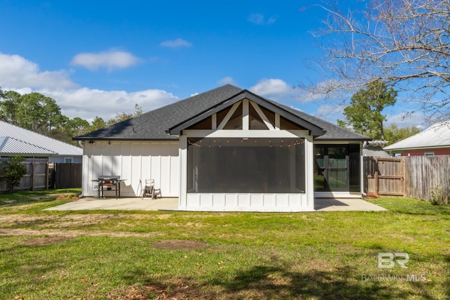 5100 Pine Way, Orange Beach, AL 36561 - rear view of property with a fenced backyard, a yard, board and batten siding, a patio, and a sunroom