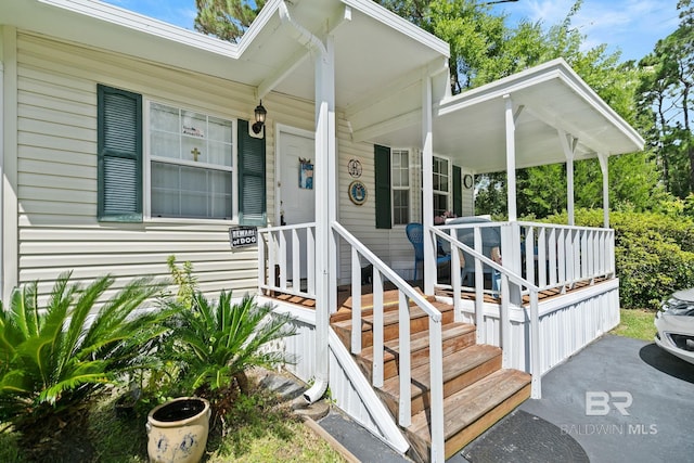 doorway to property featuring covered porch