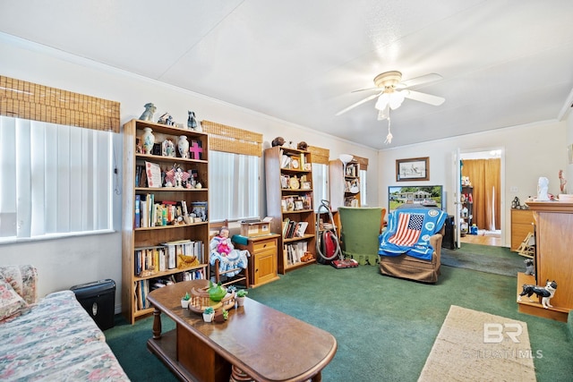 interior space with crown molding, dark carpet, and ceiling fan