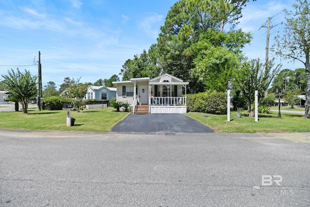 view of front of house with a porch and a front yard