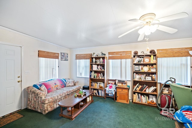 carpeted living room with crown molding and ceiling fan