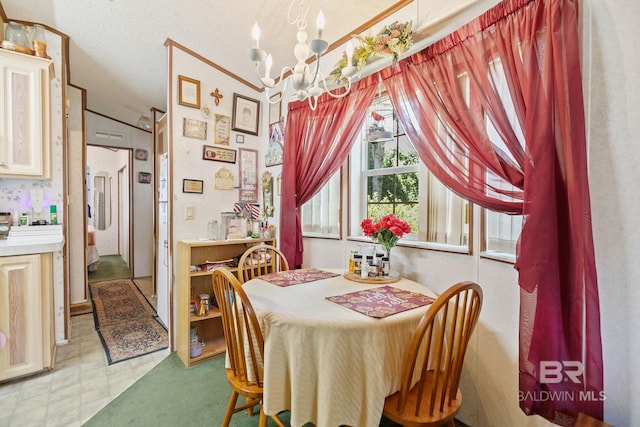 dining space featuring a notable chandelier, tile patterned floors, lofted ceiling, and a textured ceiling