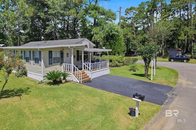 view of front of home featuring covered porch and a front lawn