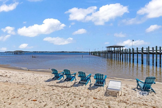 property view of water with a beach view and a dock