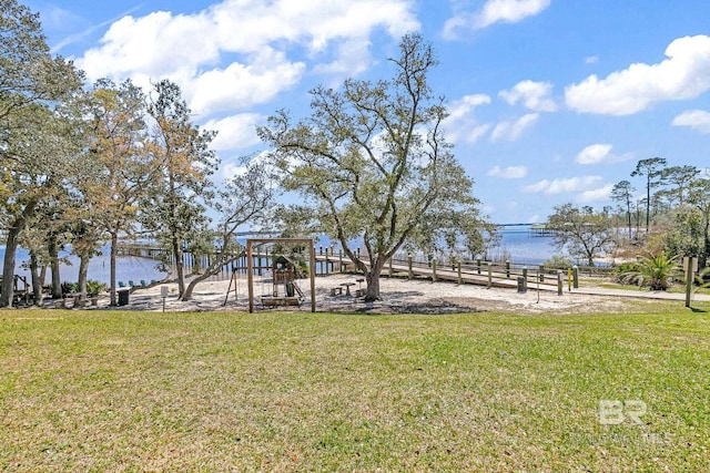 exterior space featuring a yard, a water view, and a playground