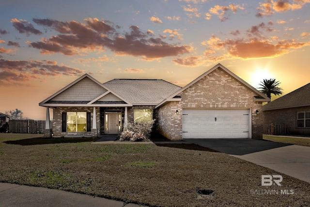 view of front of house with a garage and a lawn