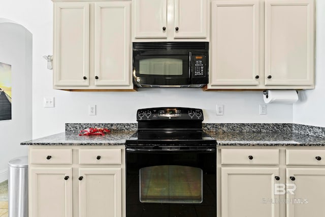 kitchen with black appliances and dark stone counters