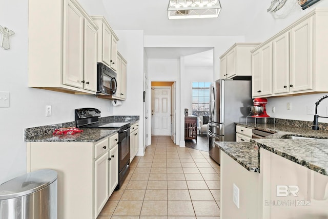 kitchen with light tile patterned flooring, sink, black appliances, dark stone counters, and white cabinets