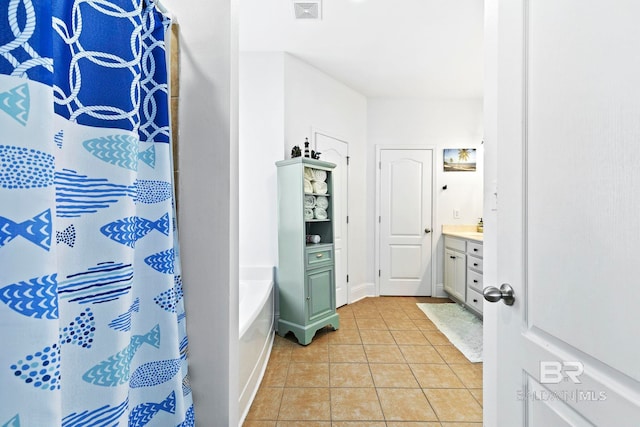 bathroom featuring vanity, tile patterned floors, and separate shower and tub