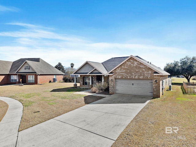 view of front of house featuring a garage and a front lawn