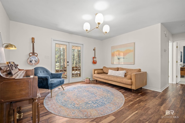 living room featuring wood finished floors, a notable chandelier, french doors, and baseboards