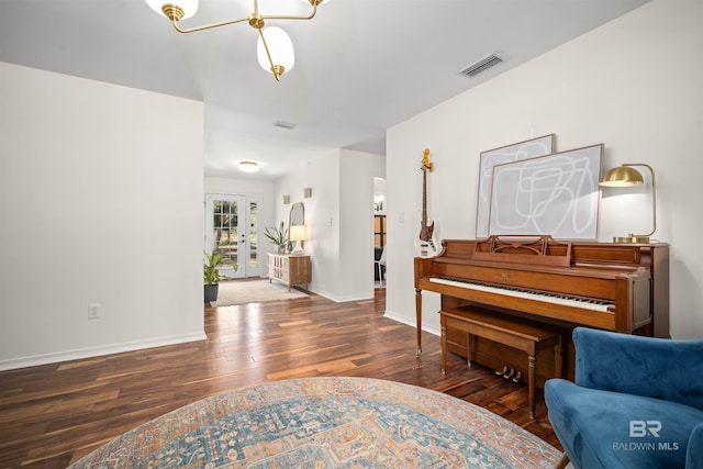 sitting room featuring visible vents, baseboards, french doors, and hardwood / wood-style flooring