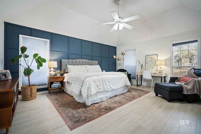 bedroom with light wood-type flooring, ceiling fan, and vaulted ceiling