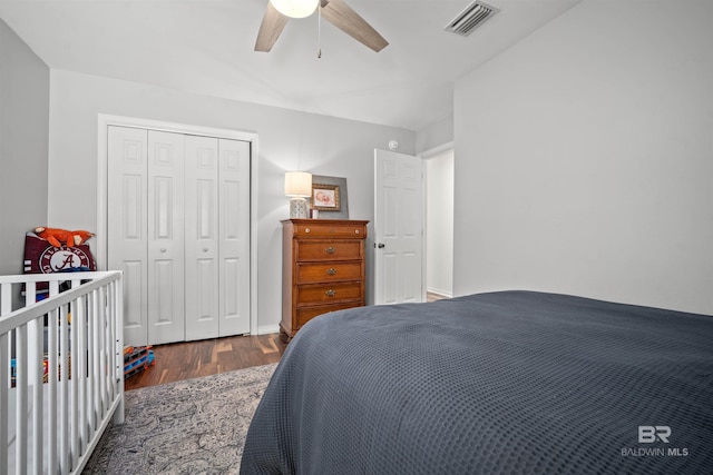 bedroom featuring a closet, visible vents, a ceiling fan, and wood finished floors