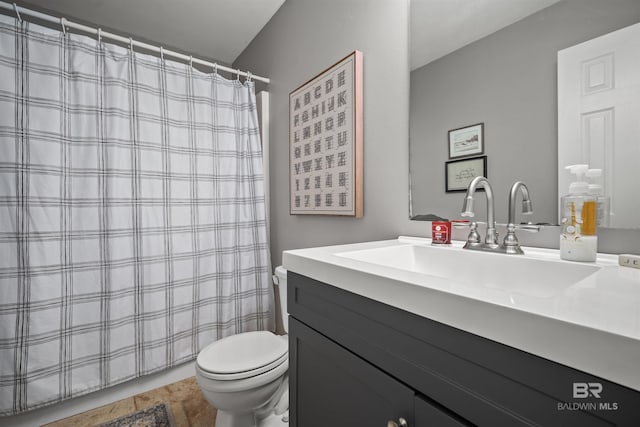 bathroom featuring vanity, curtained shower, and toilet