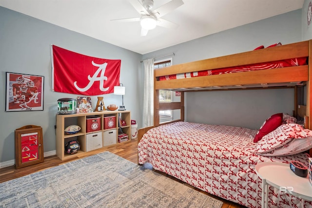 bedroom with ceiling fan, baseboards, and wood finished floors