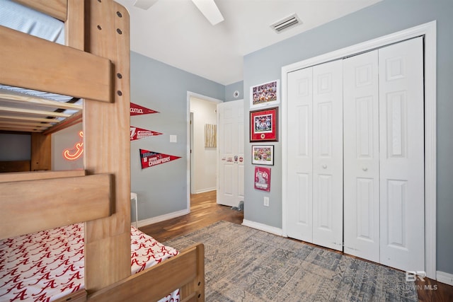 bedroom featuring visible vents, baseboards, and wood finished floors