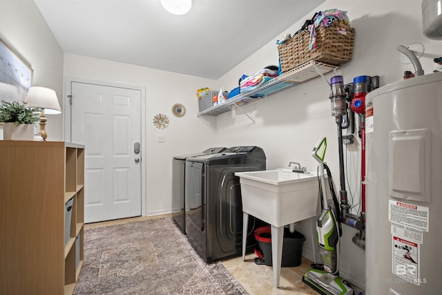 laundry room featuring independent washer and dryer, laundry area, baseboards, and water heater