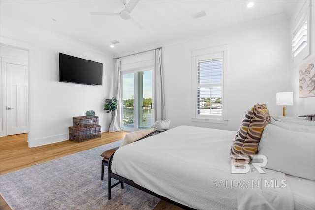 bedroom featuring a ceiling fan, wood finished floors, recessed lighting, crown molding, and access to outside