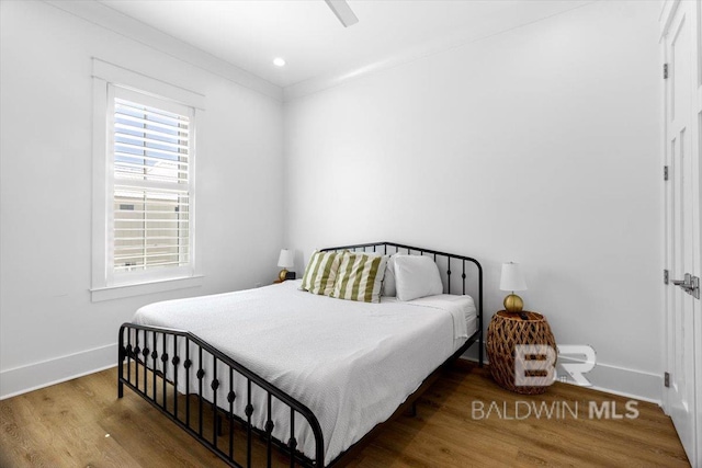 bedroom featuring recessed lighting, a ceiling fan, baseboards, and wood finished floors