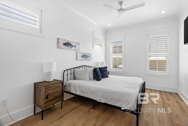 bedroom featuring recessed lighting, multiple windows, light wood-style flooring, and baseboards