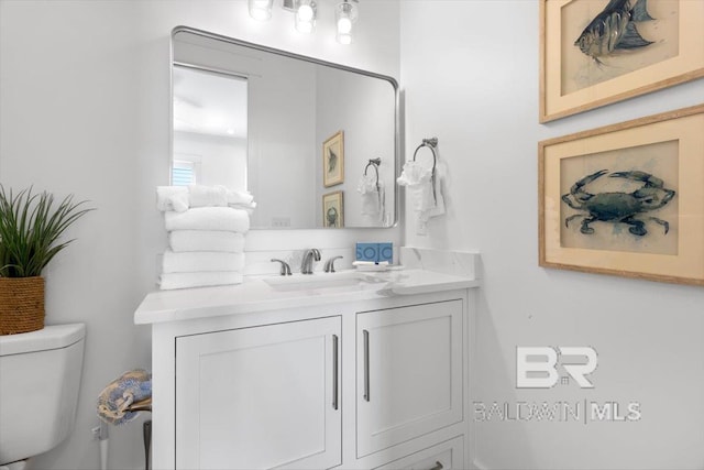 bathroom with toilet and vanity