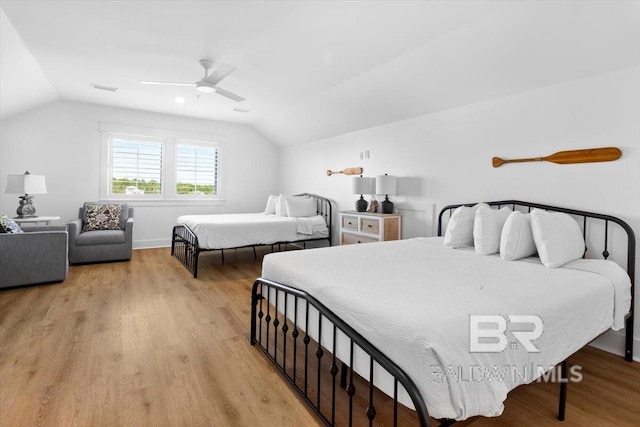 bedroom with visible vents, lofted ceiling, ceiling fan, and light wood finished floors