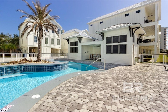 pool featuring a patio area, fence, and ceiling fan