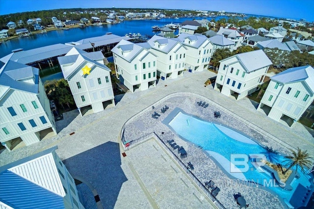 bird's eye view featuring a water view and a residential view