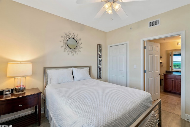 tiled bedroom with a closet and ceiling fan