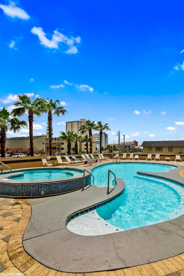 view of pool featuring a patio and a jacuzzi