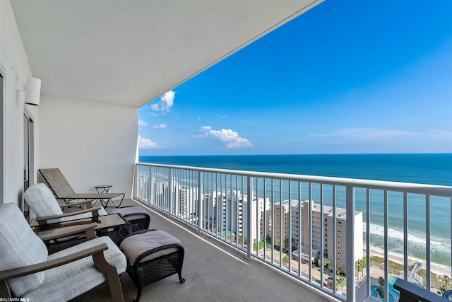 balcony with a water view and a beach view