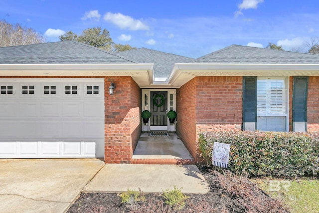 property entrance featuring brick siding, a garage, and a shingled roof